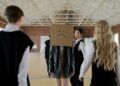 Students in a school gym highlighting themes of bullying and peer pressure.