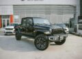 Black Jeep Gladiator Rubicon showcased outside RAWA Auto Auction dealership.