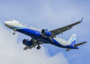 An IndiGo Airbus A320 Neo captured mid-flight against a bright blue sky, showcasing modern aviation technology.