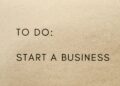A close-up shot of a to-do list with 'Start a Business' written on it.