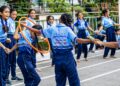 Group of schoolchildren enjoying outdoor games with hula hoops at a school event in Surat, India.