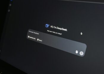 Close-up of DeepSeek AI chat interface on a laptop screen in low light.