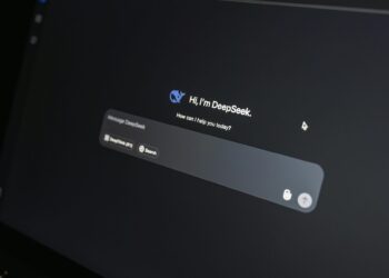 Close-up of DeepSeek AI chat interface on a laptop screen in low light.