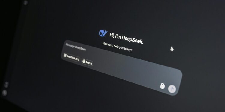 Close-up of DeepSeek AI chat interface on a laptop screen in low light.