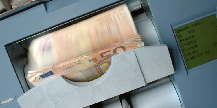 50 Euro banknotes being processed in a high-speed counting machine, showcasing technology and finance in action.
