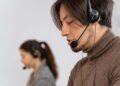 Focused call center employees wearing headsets, assisting customers with exceptional service.