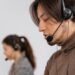 Focused call center employees wearing headsets, assisting customers with exceptional service.