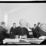 Admiral Sims testifying before a committee, illustrating a historical hearing on global risks.