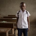 A boy in a classroom at school, illustrating the end of Valmiki Jayanti school closures.