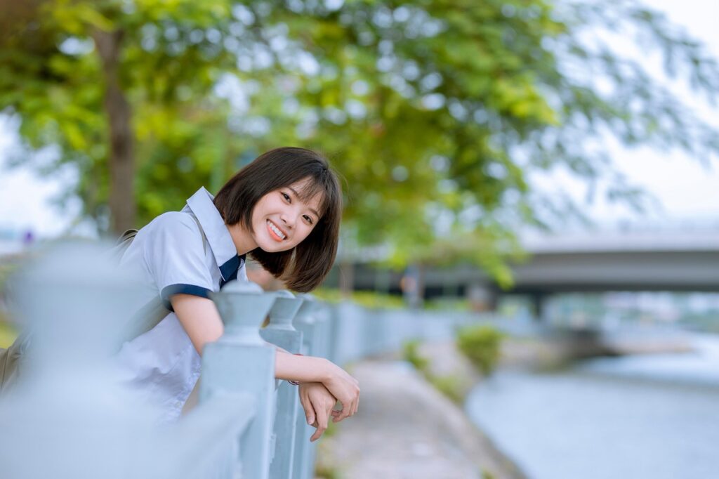 A smiling student in a school uniform, illustrating the Labor Department’s support for rural training across three regions.