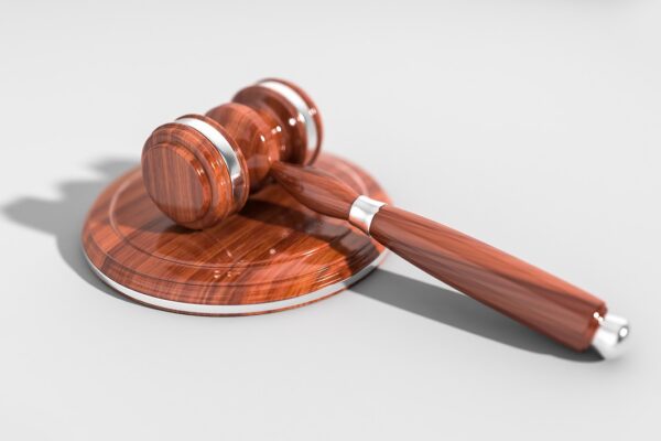 A wooden gavel on a surface, illustrating the Irish High Court ruling on a visa refusal.