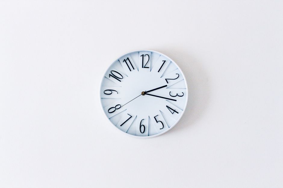 Simple minimalist wall clock on a white wall for a clean aesthetic