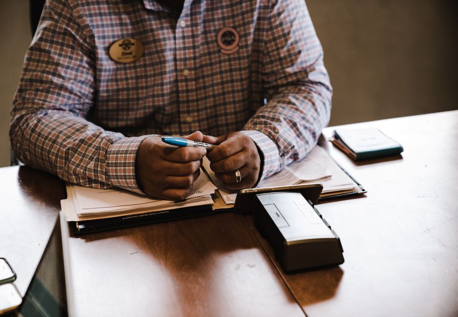A businessman organizing documents at his desk, illustrating the initiative to help actors maintain insurance coverage.