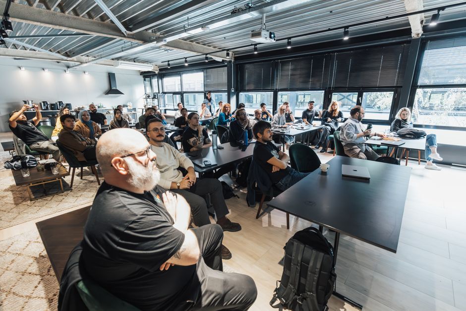 Stock photo of A diverse group of professionals attentively listening during an indoor business meeting in a, used to illustrate this story on Goa Conclave Calls for New University Models, AI and Research.