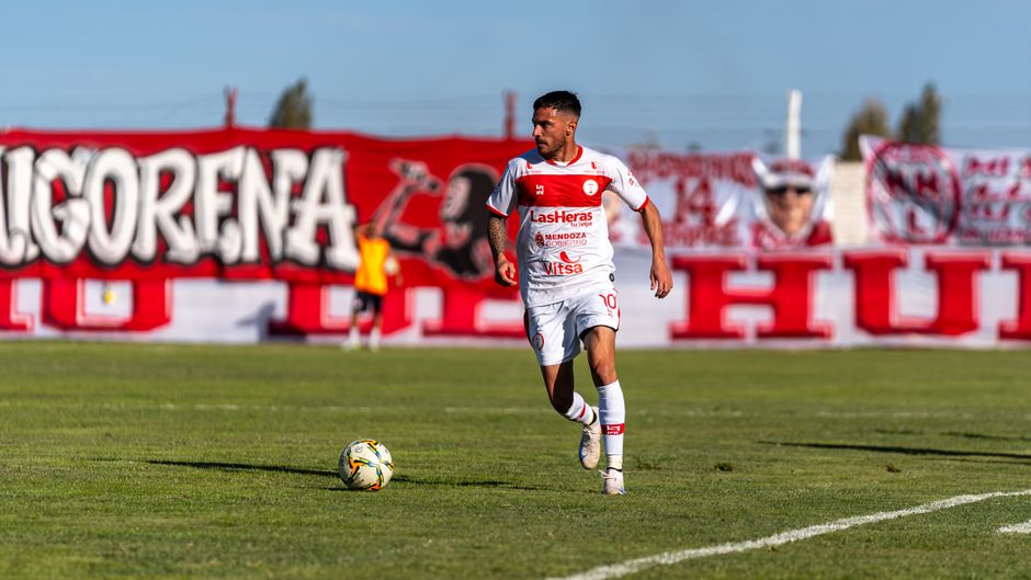 A football player in action on a sunny field, illustrating the sports context of the Mbappé brand controversy.