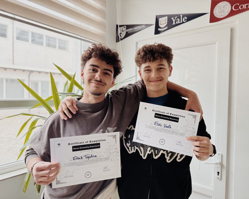 Two young adults display graduation certificates in a classroom, illustrating an article about eMudhra Intermediate CA key compromise.