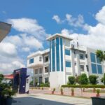 A contemporary university building beneath a blue sky, illustrating a survey on student entrepreneurship in India.