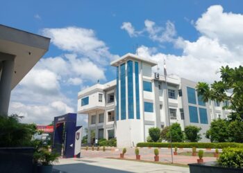 A contemporary university building beneath a blue sky, illustrating a survey on student entrepreneurship in India.