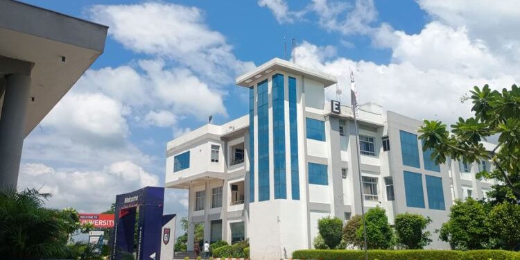 A contemporary university building beneath a blue sky, illustrating a survey on student entrepreneurship in India.