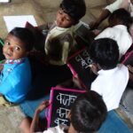 Young students writing on slates in a village school, illustrating calls to prepare students for creator-economy jobs.