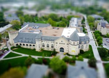 An aerial view of a university campus with modern buildings and greenery, illustrating course-based scholarship choices for students.