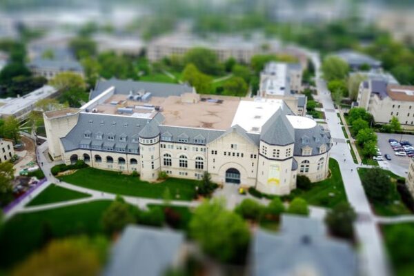 Aerial view of a Manhattan, Kansas campus with modern buildings and green lawns, illustrating BITS Pilani's AI curriculum shift.