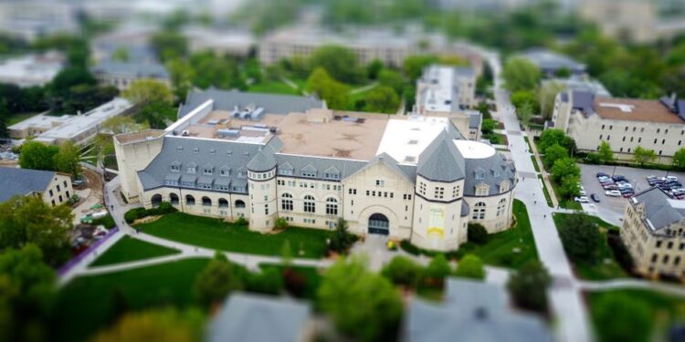 An aerial view of a university campus with modern buildings and greenery, illustrating course-based scholarship choices for students.