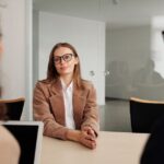 A young woman attending a job interview in a modern office, illustrating an article about HDFC Bank's data leak probe.