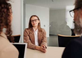 A young woman attending a job interview in a modern office, illustrating an article about HDFC Bank's data leak probe.