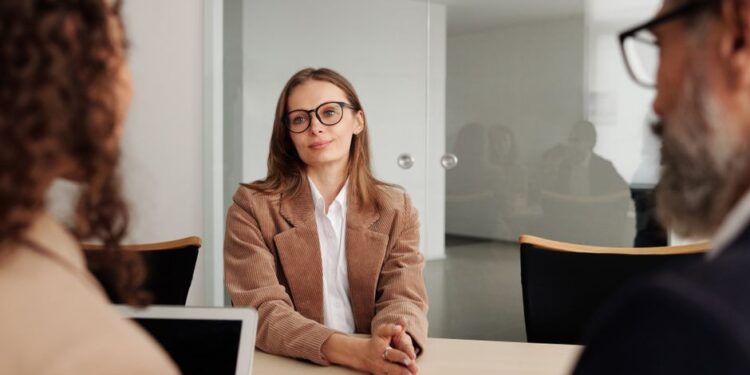 A young woman attending a job interview in a modern office, illustrating an article about HDFC Bank's data leak probe.