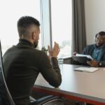 Two men in a modern office interview setting, illustrating SBI's AI Specialist Officer recruitment.