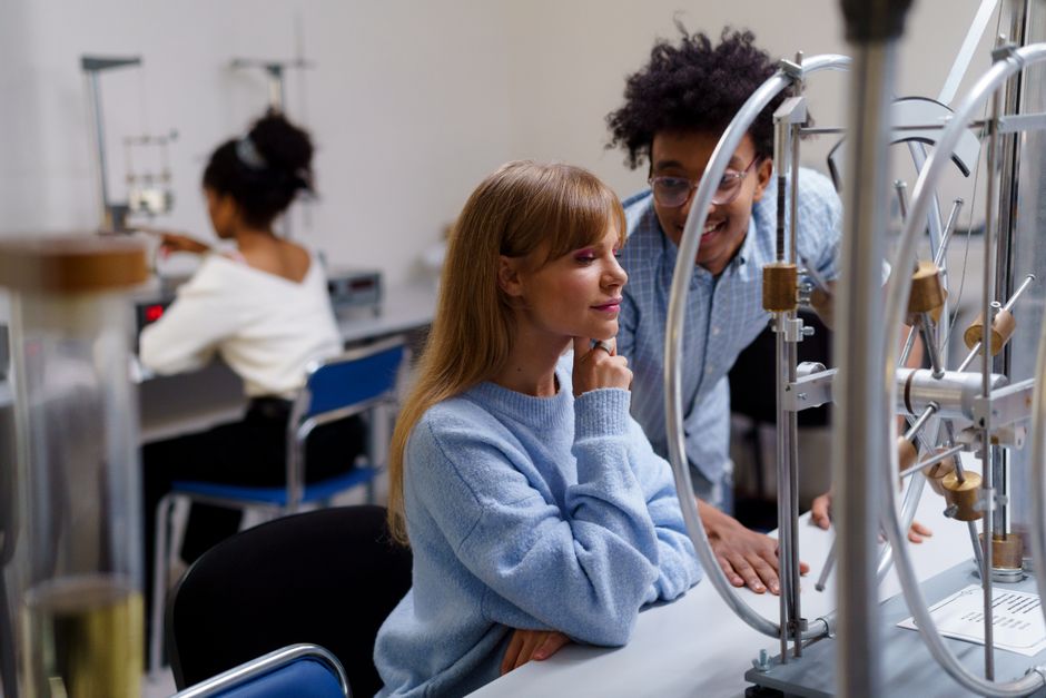 College students collaborating on a science experiment in a lab, illustrating the growing demand for study abroad programs in Brazil.