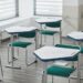 Empty classroom with desks, exam papers and pencils arranged, illustrating the Telangana SSC March 2027 exam fee schedule.