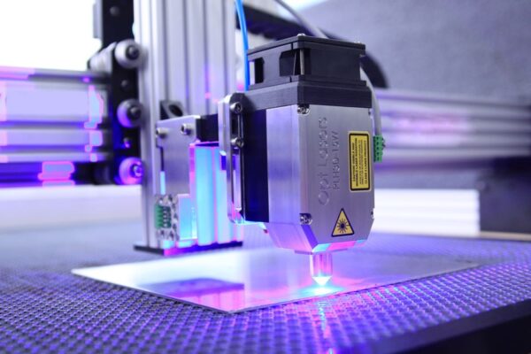An industrial laser engraving machine in action, illustrating the Pentagon's laser weapon prototype funding.