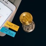 Bitcoin coins and a smartphone displaying a price chart, illustrating Gen Z investing early.