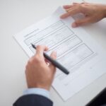 A business professional reviewing an application form at a desk, illustrating the extended government job age limit in Andhra Pradesh.