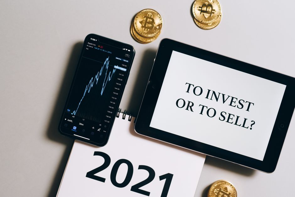 A tablet and smartphone displaying charts beside Bitcoin coins, illustrating the article on Gen Z opening retirement accounts earlier.