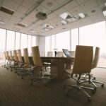 An oval brown wooden conference table with chairs in a room, illustrating a CEO's authority rule.