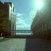 Sun shining brightly on a city street, illustrating the urban work environment affected by AI layoffs.