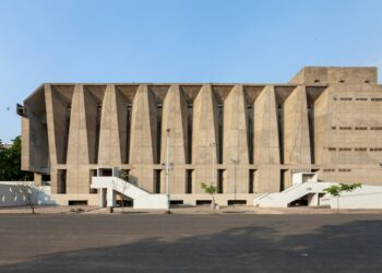 An empty parking lot outside a large building, illustrating the VITEEE 2027 registration announcement.