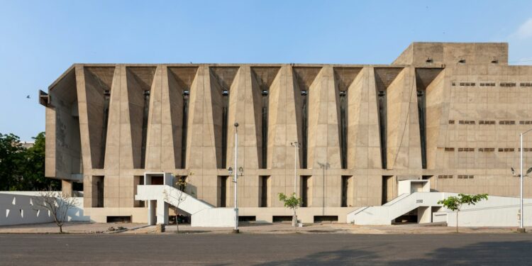 An empty parking lot outside a large building, illustrating the VITEEE 2027 registration announcement.