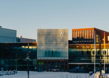 A multi‑windowed building covered in snow, illustrating AI raising entry‑level standards in engineering.