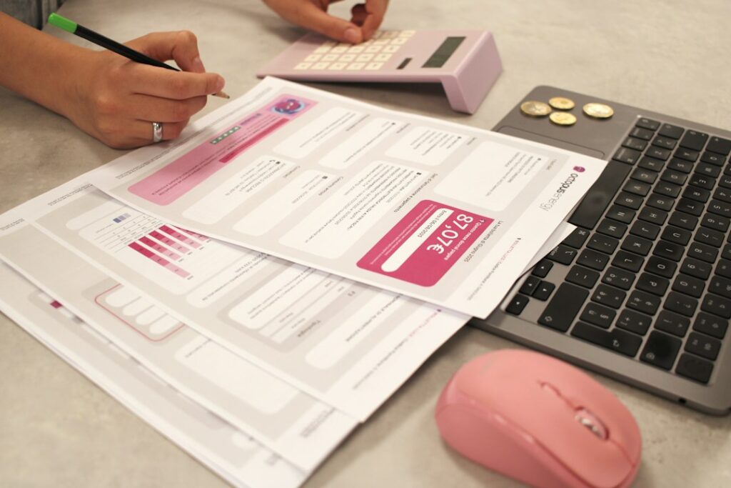 A person using a calculator and laptop for taxes, illustrating the UGC window closing and IIT AI degree options.
